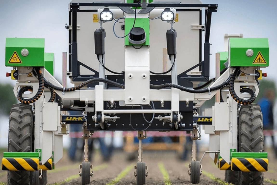 Autonominio žemės ūkio roboto priekis su jutikliais, apšvietimu ir važiuokle, skirta tiksliam darbui tarpueiliuose.
