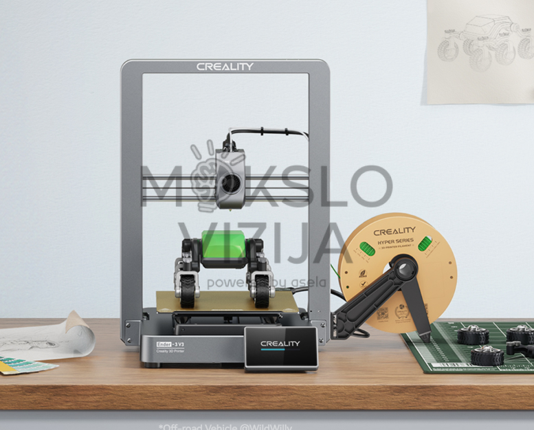 Atviro tipo 3D spausdintuvas su metaliniu rėmu, spausdinimo galvute centre ir gijos rite šalia ant darbo stalo.