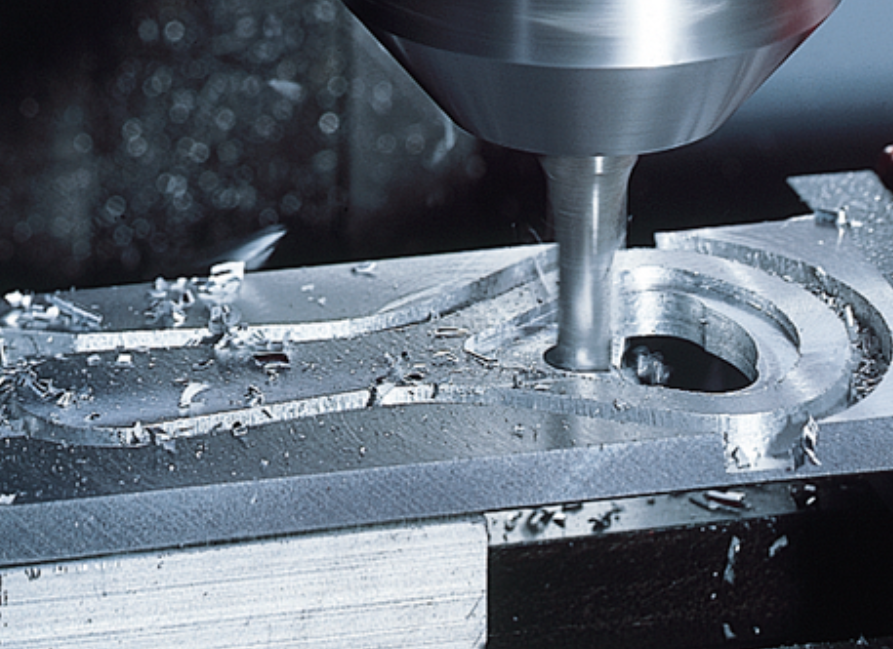 CNC frezavimo procesas, kai frezavimo įrankis apdirba metalinę detalę ir formuoja jos paviršių CNC frezavimo staklėse.