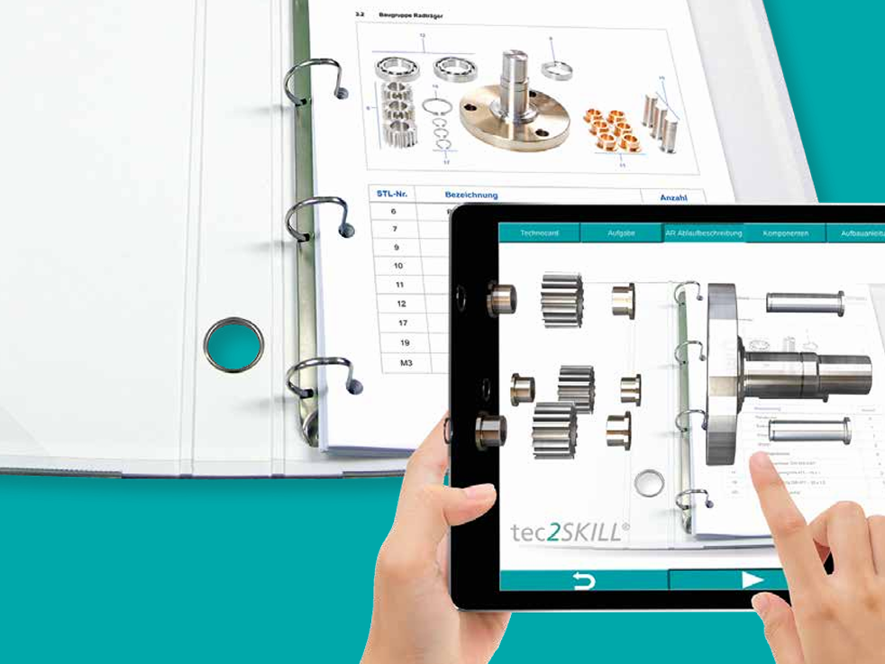 Planšetė su papildytos realybės mechanikos mokymo programa ir pavarų komponentų modeliu.